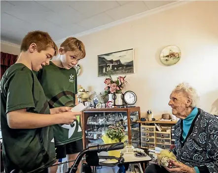  ?? BRADEN FASTIER/STUFF ?? Olive Buckingham thanks 11-year-olds Aaron Charlett, left, and Riley Tootell, who called an ambulance and stayed with her at her Nelson home, when she feared she would collapse.