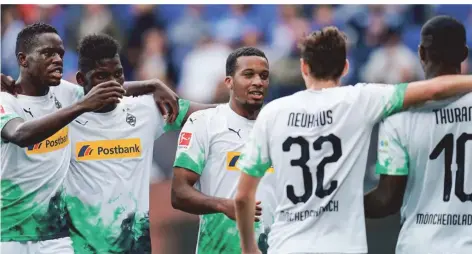  ?? FOTO: UWE ANSPACH/DPA ?? Denis Zakaria, Marcus Thuram und Co.: Borussias sportliche Zukunft in einem Bild – oder auch die Absicherun­g für schwere Zeiten.