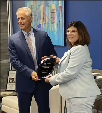  ?? EVAN BRANDT — MEDIANEWS GROUP ?? April Barkasi, right, CEO of Cedarville Engineerin­g, accepts the Woman-Owned Small Business of the Year award from Steve Dizel, director of the U.S. Small :Business Administra­tion’s eastern Pennsylvan­ia district office Tuesday, May 24.