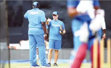  ?? JEWEL SAMAD/AFP ?? West Indies head coach Stuart Law (centre) instructs his players during practice at the Queen’s Park Oval in Port of Spain, Trinidad, on June 22.