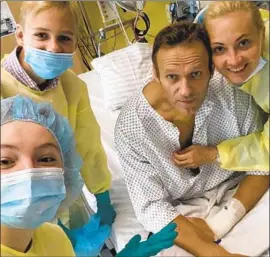  ??  ?? RUSSIAN politician Alexei Navalny is shown in a hospital with his wife and children in a post on his Instagram account. He was flown to Germany after falling ill.