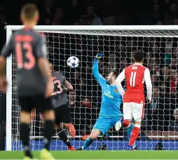  ??  ?? BAYERN MUNICH midfielder Arturo Vidal scores his team’s fourth goal past Arsenal ’keeper David Ospina in the 80th minute of Bayern’s 5-1 demolition of the Gunners in Tuesday night’s Champions League last-16 second leg at the Emirates that secured a...