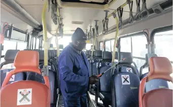  ?? | ITUMELENG ENGLISH African News Agency (ANA) ?? A REA Vaya employee disinfects a bus at the Dobsonvill­e, Soweto, depot.