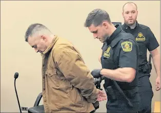  ?? TARA BRADBURY/THE TELEGRAM ?? A sheriff handcuffs James Pendergast of Bell Island and prepares to take him back to prison, where he will serve the 18 months he has remaining on his 30-month sentence for a break-in and arson.