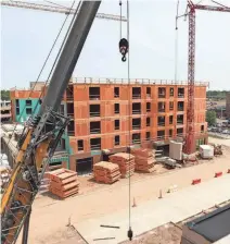  ?? SYMMONE GAUER/ARGUS LEADER ?? Constructi­on in June on The Dakota retail and apartment building of the Cherapa developmen­t in downtown Sioux Falls.
Last year, the city permitted 2,682 new residentia­l units, including 1,930 multi-family, 421 single-family homes and 331 townhomes.