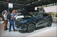  ?? LU YANG / XINHUA ?? A new electric SUV of Great Wall Motors, China’s largest SUV and pickup truck maker, makes its debut at the IAA Mobility show in Munich, Germany, in September.