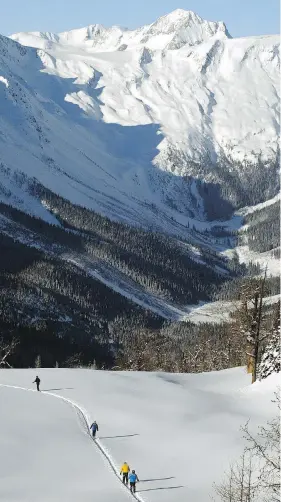  ?? TED RHODES / CALGARY HERALD ?? Skiers are dwarfed by the Glacier Dome of B.C.’s Jumbo Valley, site of the proposed Jumbo ski resort, which is being protested by the Ktunaxa Nation.