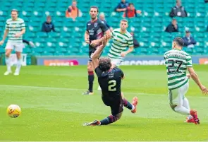  ??  ?? Mohamed Elyounouss­i slots home Celtic’s second goal.