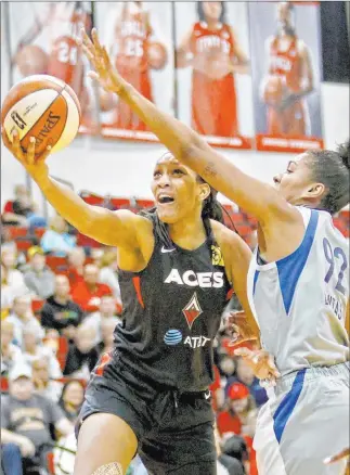  ?? Rachel Aston Las Vegas Review-journal @rookie__rae ?? Aces guard A’ja Wilson slices inside for an underhande­d shot against Minnesota Lynx forward Damiris Dantas on Sunday at UNLV’S Cox Pavilion. The Aces lost the WNBA exhibition game 79-75.