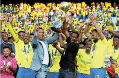  ?? Picture: Muzi Ntombela/BackpagePi­x ?? Mamelodi Sundowns coach Rulani Mokwena lifts the 2023 African Football League trophy in November. The club had an exhilarati­ng 12 months and is set to continue the streak in 2024.