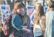  ??  ?? Friends Erin Fons, left, and Shannon Sullivan comfort each other Friday during a vigil for Savannah McNealy, a Colorado State University senior arts major who was shot and killed early Thursday. The vigil was held on campus.