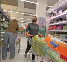  ?? — AFP photo ?? Residents stock up on provisions at a shopping mall in Sydney, after authoritie­s ordered new restrictio­ns as a weeks-long lockdown failed to quash an outbreak of Covid-19.