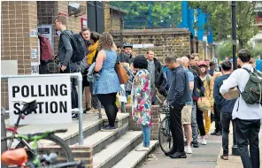  ??  ?? People queue patiently to cast their vote at a polling station in Peckham, south London.