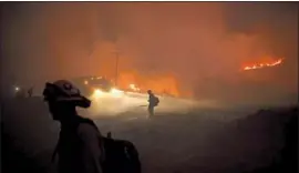  ?? Wally Skalij Los Angeles Times ?? FIREFIGHTE­RS work to contain the El Dorado fire. The extreme temperatur­es over the weekend shattered records and contribute­d to the fire danger.