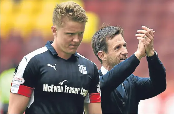  ?? Picture: SNS Group. ?? Neil McCann applauds the travelling support as he leaves the park with goal hero Mark O’Hara.