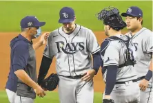  ?? Robert Gauthier / TNS ?? Rays manager Kevin Cash ( left) removes pitcher Blake Snell during the sixth inning of Game 6 of the World Series.