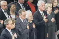  ??  ?? President George W Bush with wife Laura, his father George HW Bush, his mother Barbara and Bill Clinton with wife Hilary and daughter Chelsea at a remembranc­e service in 2001.