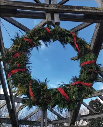  ?? (Courtesy Photo) ?? The Botanical Garden of the Ozarks in Fayettevil­le has on display what is believed to be the largest living wreath in the region. Created by horticultu­re designer Lee Witty, the wreath is approximat­ely 7 feet across and consists of about 18 plant and tree varieties, including muscadine vine, arborvitae, Colorado blue spruce, American holly, cedar, osmanthus and pine. Witty used the prunings from the trees and plants in the garden to create this beauty. The wreath is hanging under the arbor on the Great Lawn. The BGO is open 9 a.m.-5 p.m. Friday-Tuesday and closed on Wednesdays and Thursdays.