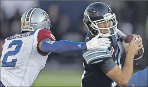  ??  ?? Toronto Argonauts’ Ricky Ray (15) is sacked by Montreal Alouettes’ Jovon Johnson (2) during CFL action in Toronto on Monday, July 25, 2016. $1 1)050