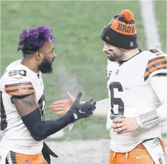  ?? CHARLES LECLAIRE • USA TODAY SPORTS ?? Cleveland Browns quarterbac­k Baker Mayfield (6) celebrates with wide receiver Jarvis Landry (80) on the sideline against the Pittsburgh Steelers during their AFC Wild Card playoff game at Heinz Field on Sunday. The Browns upset the Steelers 48-37.