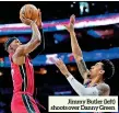  ?? ?? Jimmy Butler (left) shoots over Danny Green