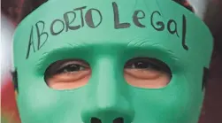  ?? NATACHA PISARENKO/AP FILE ?? An activist’s mask reads in Spanish “Legal Abortion” in Buenos Aires in 2020, when Argentina legalized abortion until the 14th week.