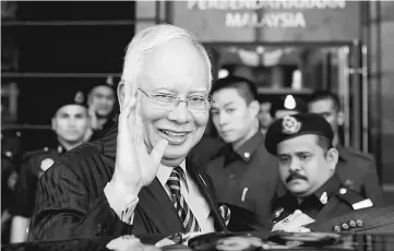  ??  ?? Najib waving to the press during a visit to the Treasury at the Finance Ministry to check on the final preparatio­ns for the Budget 2018 which he will table today at the Dewan Rakyat. — Bernama photo