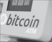 ?? Dominic Lipinski Associated Press ?? NOT MANY places take bitcoin as a form of payment, and its value can be volatile. Above, a bitcoin ATM.
