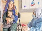  ?? Picture: SAVE THE CHILDREN VIA AP/FILE ?? A Save the Children nutrition counsellor, right, explains to Nelab, 22, how to feed her 11-month-old daughter, Parsto, with therapeuti­c food, which is used to treat severe acute malnutriti­on, in Sar-e-Pul province
of Afghanista­n, Thursday, September 29, 2022.