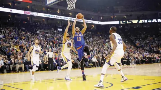  ??  ?? OAKLAND: Joakim Noah #13 of the New York Knicks goes up for a shot on JaVale McGee #1 of the Golden State Warriors at ORACLE Arena on Thursday in Oakland, California. —AFP