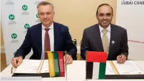  ?? — Supplied photo ?? Majid Saif Al Ghurair signs an agreement with an executive from the Lithuania Confederat­ion of Industrial­ists.