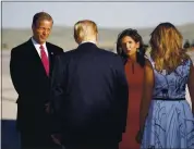  ?? ALEX BRANDON — THE ASSOCIATED PRESS ?? Sen. John Thune, R-S.D., and Gov. Kristi Noem greet President Donald Trump and first lady Melania Trump upon arrival Friday at Ellsworth Air Force Base in Rapid City, S.D.