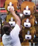  ??  ?? Mark Mulligan / Houston Chronicle A staffer restocks midway games at RodeoHoust­on.