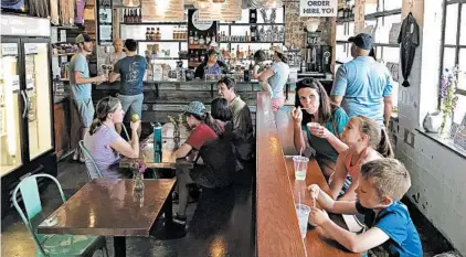  ?? LORI RACKL/CHICAGO TRIBUNE ?? Lexington’s Distillery District is home to Crank &amp; Boom Ice Cream Lounge, a fun spot to indulge in frosty treats like bourbon and honey ice cream.