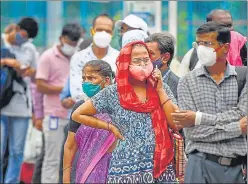  ?? PTI ?? People wait in a queue for a bus after unlocking of Covid-19 lockdown began, outside Dadar station in Mumbai on Wednesday.