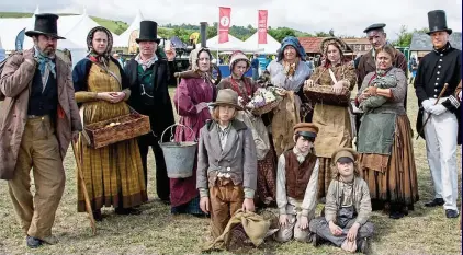  ??  ?? What the Dickens! A constable keeps order as Victorian re-enactors show their wares. Above right: Youngsters enjoy the sights next to an iconic Spitfire