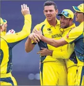  ??  ?? Josh Hazlewood (C) celebrates with teammates after taking wicket of New Zealand's Martin Guptill.