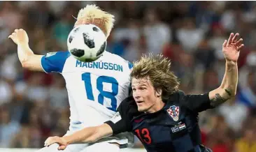  ??  ?? High action: Croatia’s Tin Jedvaj (right) vying for the ball with Iceland’s Hordur Magnusson in the Group D match at the Rostov Arena on Tuesday. — Reuters