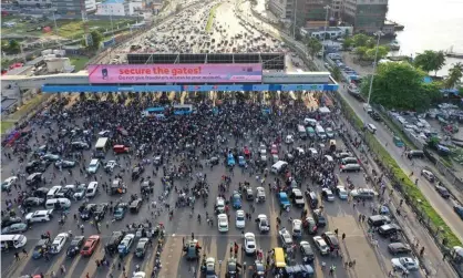  ?? Photograph: Pierre Favennec/AFP/Getty Images ?? Protesters gathering at the Lekki toll gate in Lagos in October last year, before the killings.