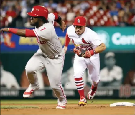  ?? JEFF ROBERSON — THE ASSOCIATED PRESS ?? St. Louis Cardinals second baseman Kolten Wong, right, chases the Phillies’ Odubel on a failed steal attempt during the eighth inning Friday night in St. Louis. Herrera before tagging Herrera out