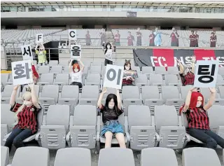  ?? RYU YOUNG-SUK THE ASSOCIATED PRESS ?? Cheering mannequins are installed at the empty spectators’ seats before the start of a soccer match between FC Seoul and Gwangju FC at the Seoul World Cup Stadium on Sunday.