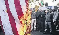  ?? PHOTO: REUTERS ?? Iranian people burn a United States flag as they mark the anniversar­y of the seizure of the US Embassy, in Teheran yesterday.