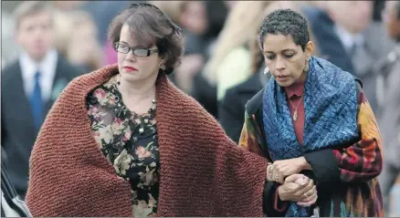  ?? Spencer Platt/getty Images ?? A grieving Veronique Pozner, left, leaves the funeral services for her son Noah on Monday in Fairfield, Conn.