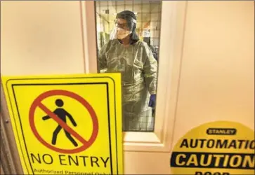  ?? Mel Melcon Los Angeles Times ?? A SIGN WARNS that only authorized people wearing personal protective gear may enter the COVID- 19 isolation area at L. A. County- USC Medical Center, where the medical director said no ICU beds are available.