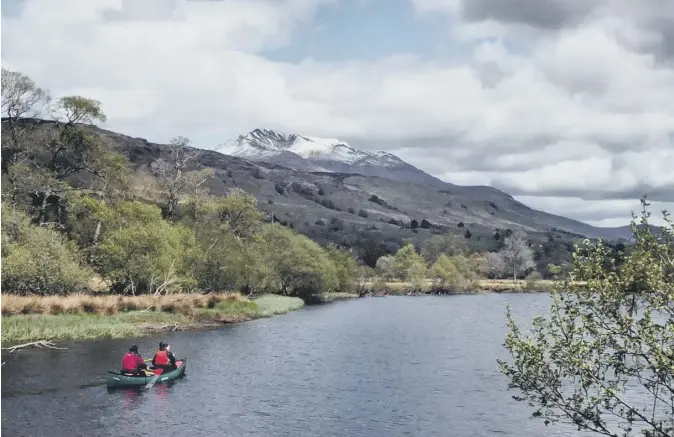  ??  ?? 0 Scotsman reader Bill Clark of Crieff contribute­s this image of two people canoeing down the River Lochay at Killin, with snow still lying on the summit of Ben Lawers