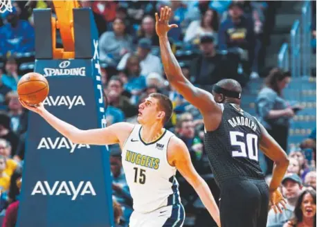  ?? David Zalubowski, The Associated Press ?? Nuggets center Nikola Jokic, working against Sacramento Kings forward Zach Randolph on Sunday, is just two triple-doubles this season behind what former Denver star guard Fat Lever recorded (nine) in 1988-89.