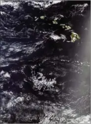  ?? NASA VIA AP ?? In this satellite image provided by NASA, the Pacific Ocean around Hawaii is shown. Two Honolulu women who set off to sail the South Pacidic on their 50-foot sailboat the Sea Nymph left the state on May 3 and ran into trouble almost immediatel­y. They...