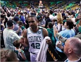  ?? Charles Krupa ?? The Associated Press Celtics forward Al Horford wades through supporters after Boston beat Milwaukee in Game 7 of their Eastern Conference first-round series on Saturday.