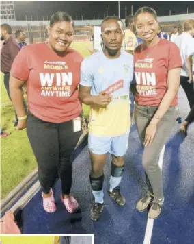  ??  ?? Precianne Miller (left), assistant digital media manager, and Kajay Rowe (right), social media manager of Supreme Ventures, hang out with Waterhouse’s Kemar Daley, goalscorer in Monday’s night game against Cavalier.