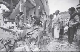 ?? AP PHOTO ?? People inspect the rubble of houses destroyed by Saudi-led airstrikes in Sanaa, Yemen. Airstrikes by a Saudi-led coalition targeted Yemen’s capital early on Friday, hitting at least three houses in Sanaa and killing at least 14 civilians, including...